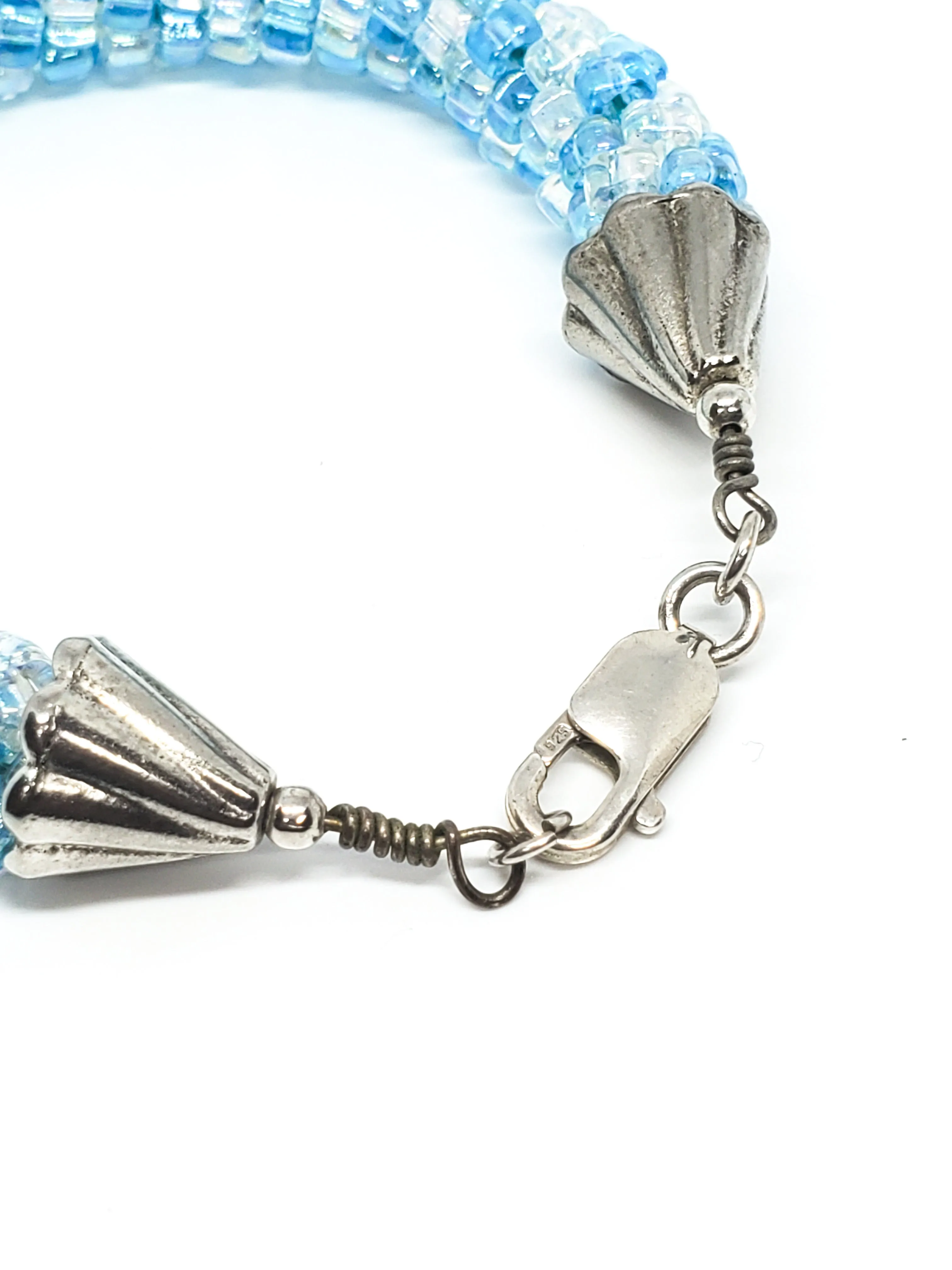 Oceans baby blue and clear torsade beaded bracelet with sterling silver clasp